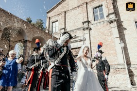 A scenic shot taken at San Fortunato Church in Rimini, Italy, featuring a colorful confetti display with a beautiful piquet of honor in the background.